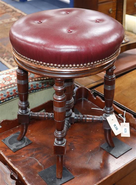 A Victorian adjustable music stool with hide-covered seat